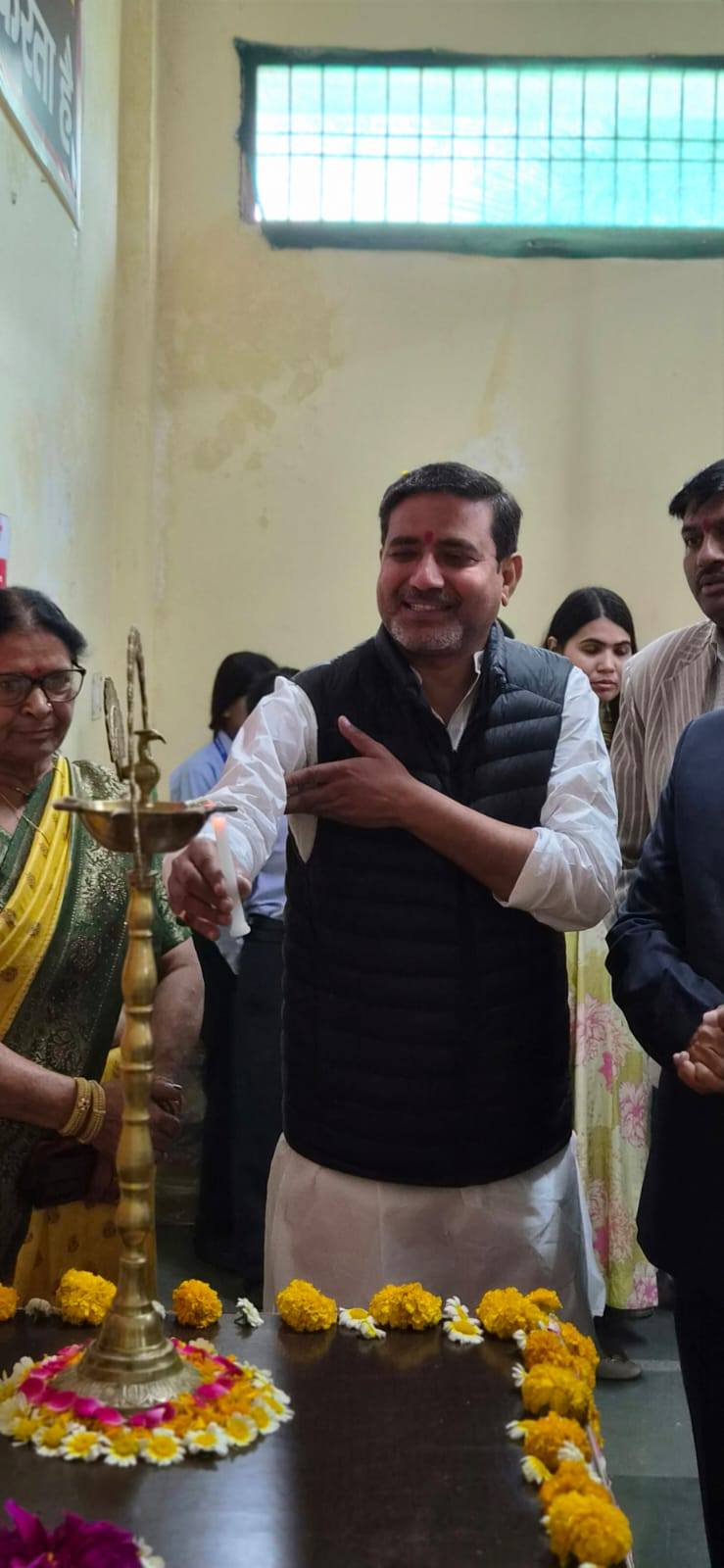 Dr. Sanjay Chaturvedi Ji lighting the ceremonial lamp at a Divya Prem Sewa Mission inauguration in Haridwar